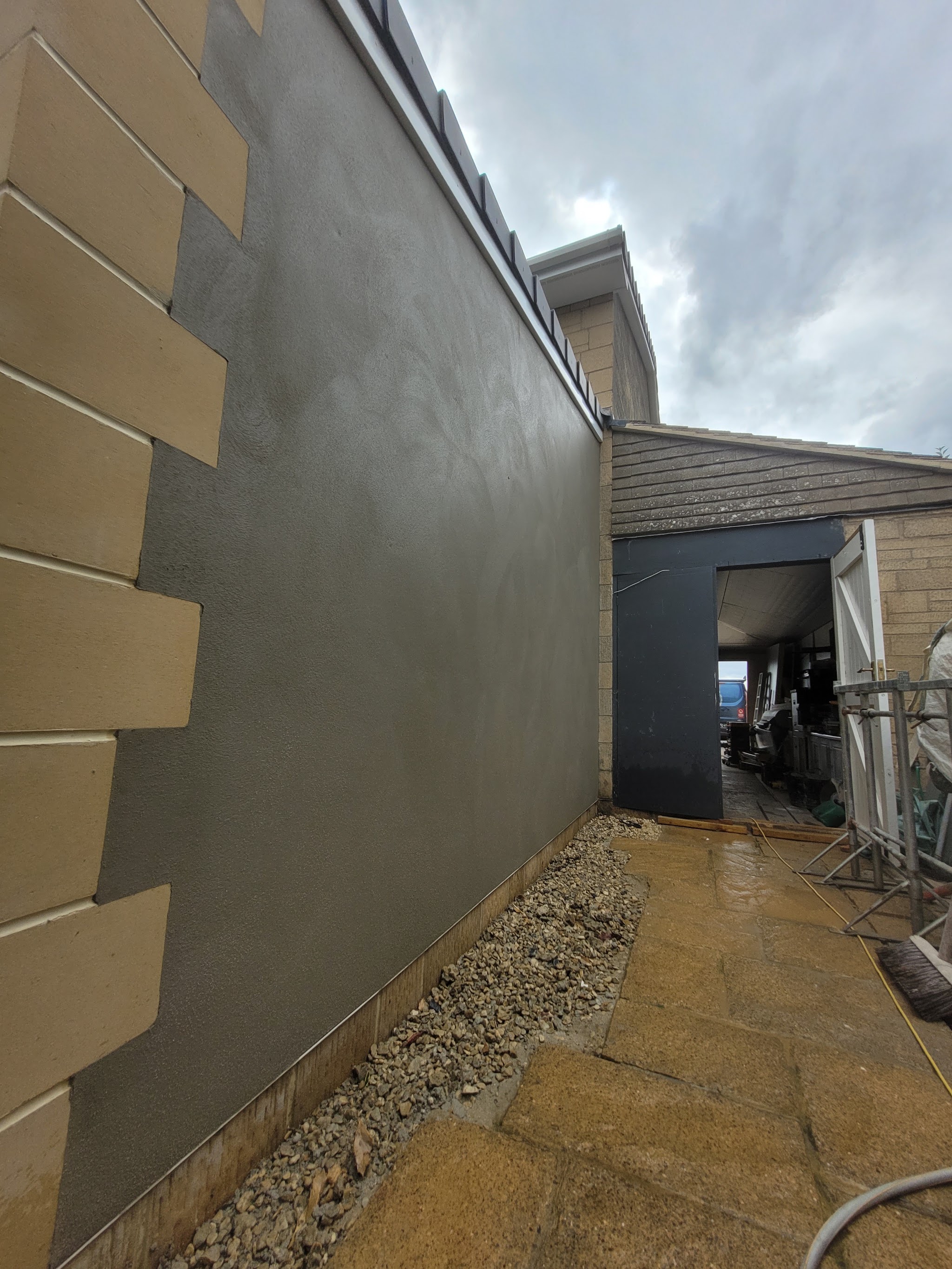 Side wall freshly rendered with raised stone effect quoins