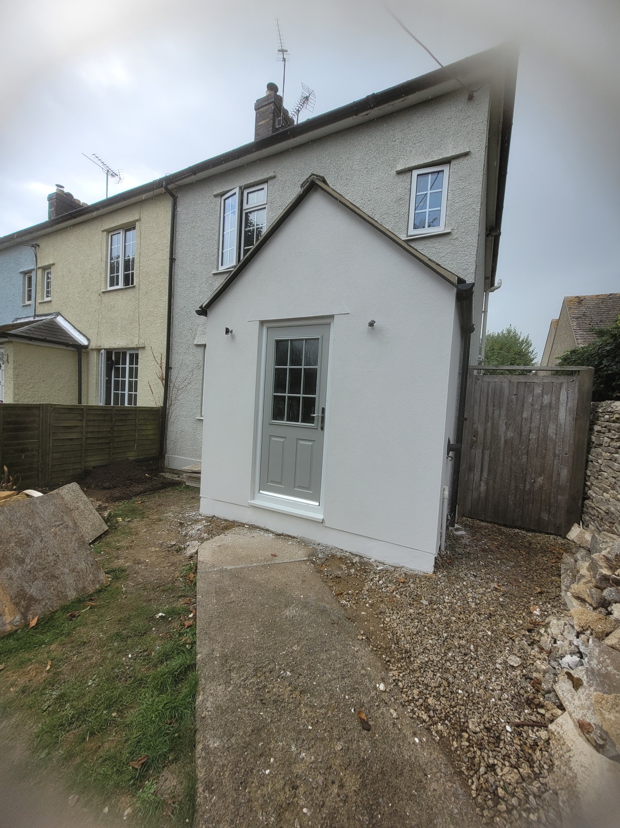 Single storey extension finished in smooth light grey render