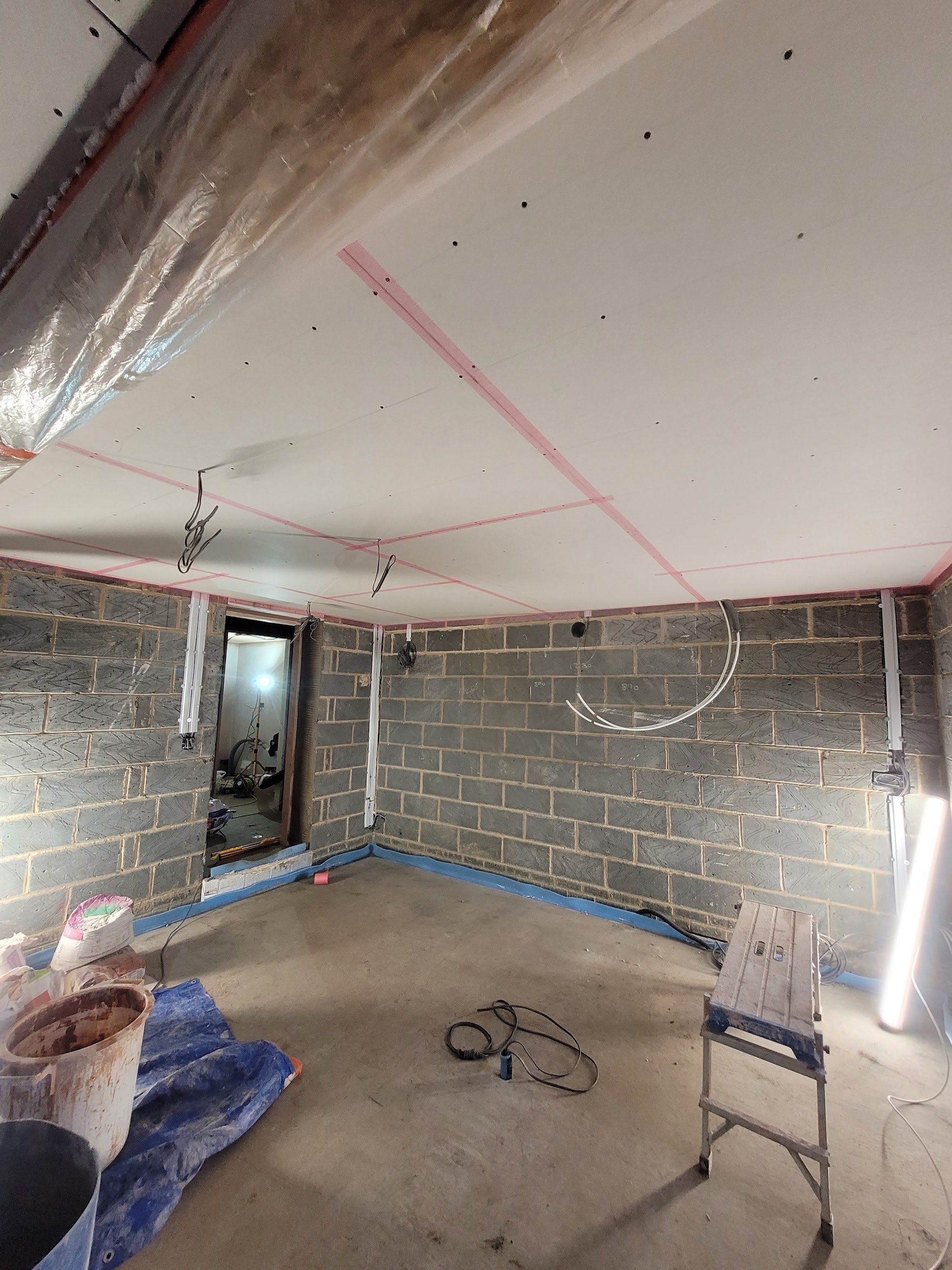 Plasterboard ceiling with scrim tape over the joints, ready for skimming